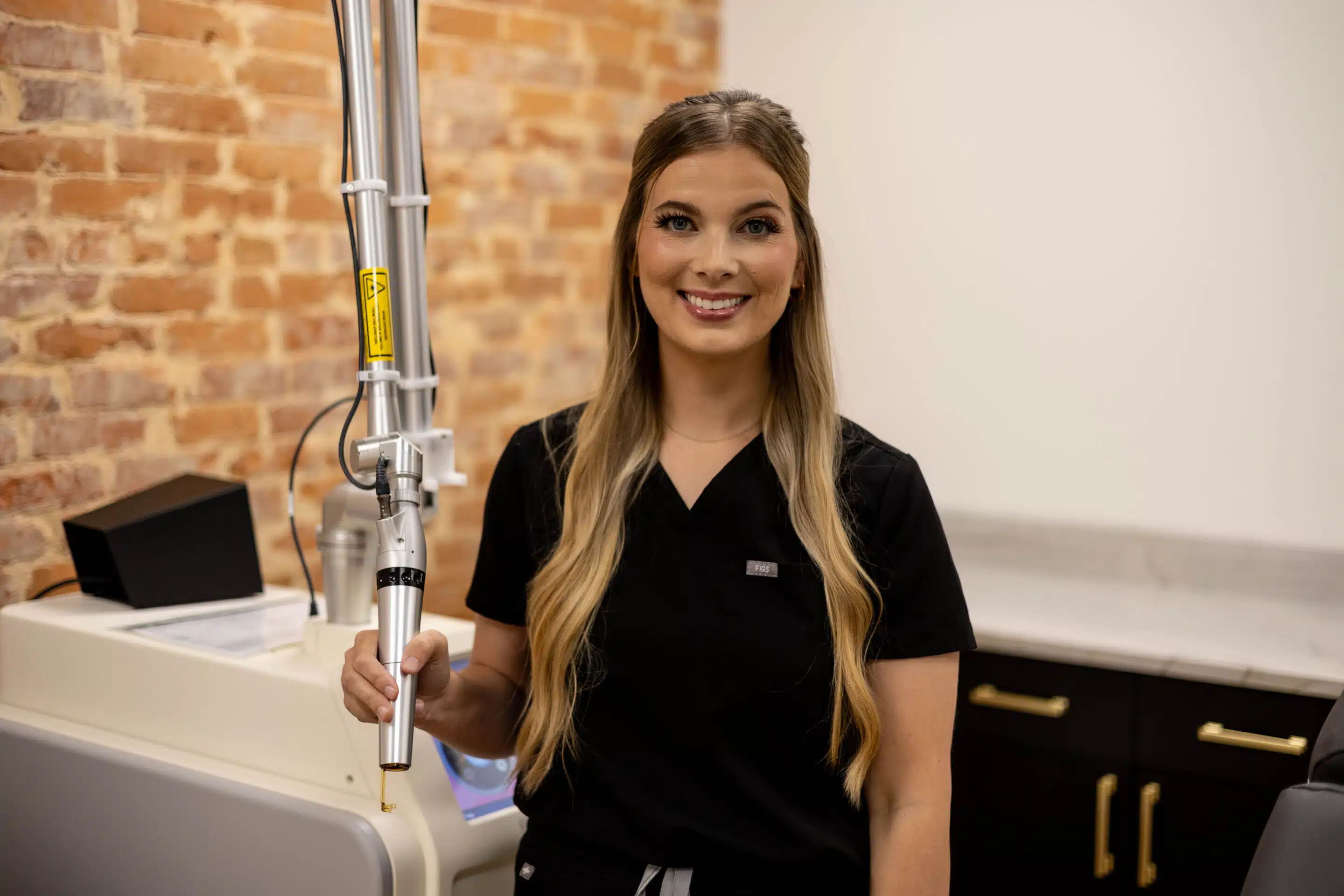 tattoo removal treatment with laser device at Camel City Injector near Winston-Salem