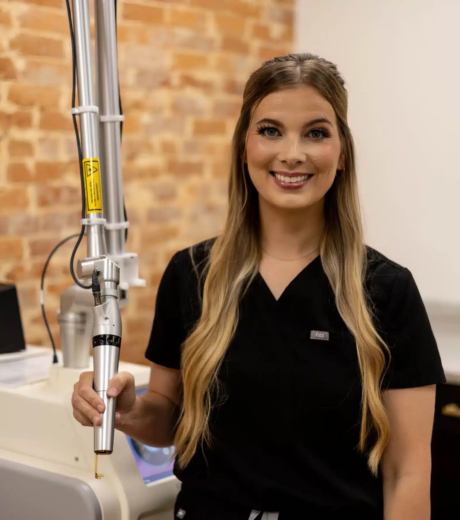 Morgan Macaranas using laser equipment at Camel City Injector